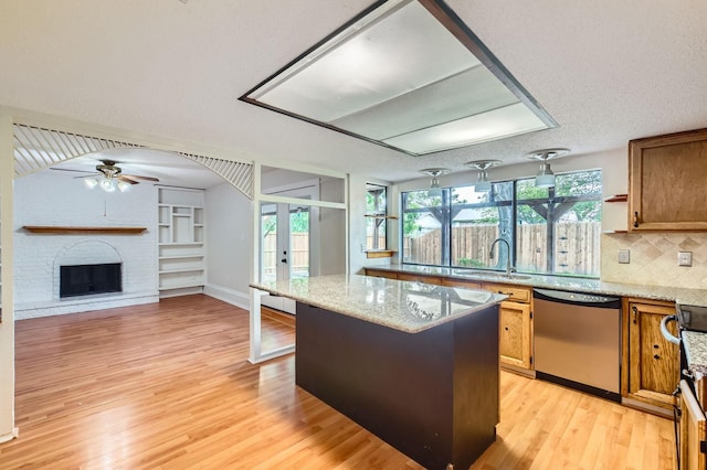 902 Via Valencia, Mesquite, TX 75150 - kitchen with stainless steel dishwasher, a ceiling fan, light wood-style flooring, french doors, and a kitchen island