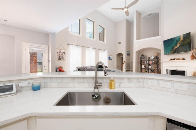 12720 Outlook Ave, Fort Worth, TX 76244 - kitchen with open floor plan, light stone counters, a high ceiling, and stainless steel dishwasher