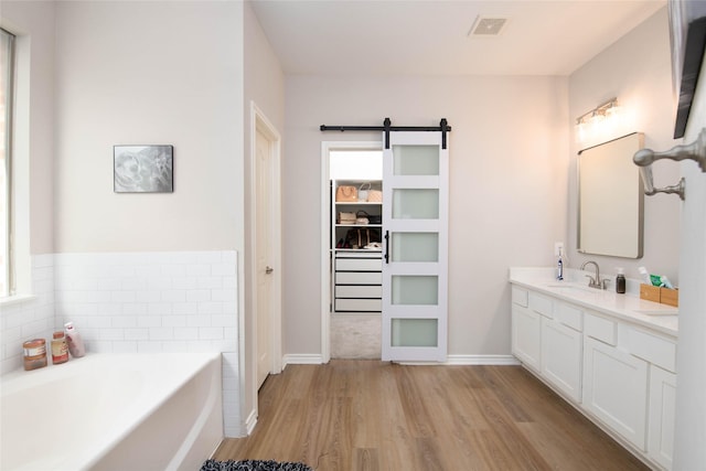 12720 Outlook Ave, Fort Worth, TX 76244 - full bathroom with wood finished floors, double vanity, healthy amount of natural light, and a garden tub