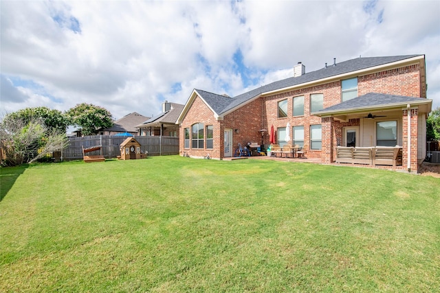12720 Outlook Ave, Fort Worth, TX 76244 - back of house with brick siding, a fenced backyard, a ceiling fan, a chimney, and a patio
