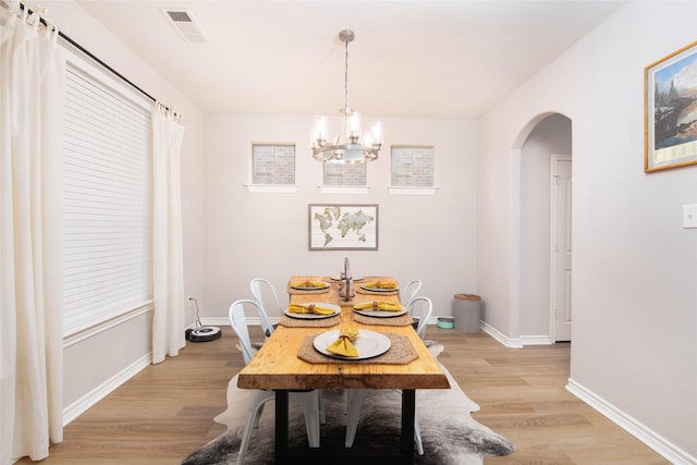 12720 Outlook Ave, Fort Worth, TX 76244 - dining area with arched walkways, light wood-style floors, and a chandelier