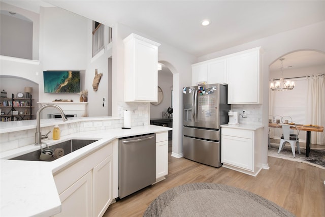 12720 Outlook Ave, Fort Worth, TX 76244 - kitchen with stainless steel appliances, tasteful backsplash, light countertops, light wood-style flooring, and white cabinetry