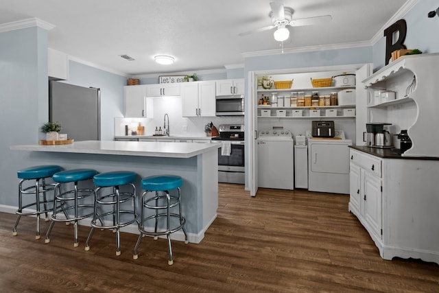 5807 Shady Hill Ln, Arlington, TX 76016 - kitchen with stainless steel appliances, washer and clothes dryer, open shelves, a peninsula, and white cabinets