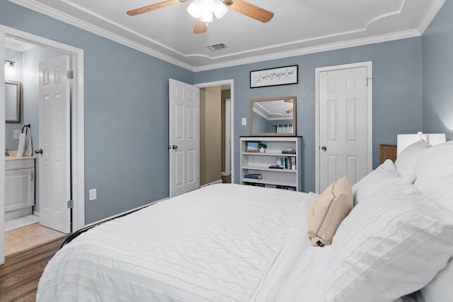 5807 Shady Hill Ln, Arlington, TX 76016 - bedroom featuring crown molding, wood finished floors, a ceiling fan, and ensuite bathroom
