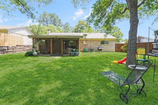 5807 Shady Hill Ln, Arlington, TX 76016 - rear view of house with a fenced backyard, a sunroom, brick siding, and a chimney
