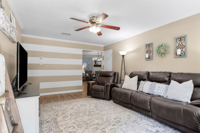 5807 Shady Hill Ln, Arlington, TX 76016 - living area with wood finished floors, a ceiling fan, a chandelier, and crown molding