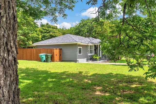 315 N Mckown Ave, Sherman, TX 75092 - rear view of house featuring roof with shingles
