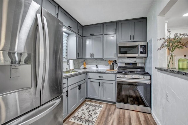 315 N Mckown Ave, Sherman, TX 75092 - kitchen featuring appliances with stainless steel finishes, gray cabinets, and light stone countertops