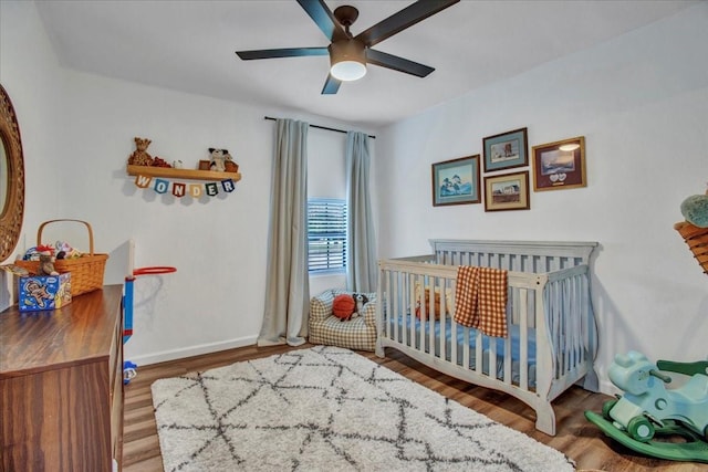 315 N Mckown Ave, Sherman, TX 75092 - bedroom featuring wood finished floors, a crib, and a ceiling fan