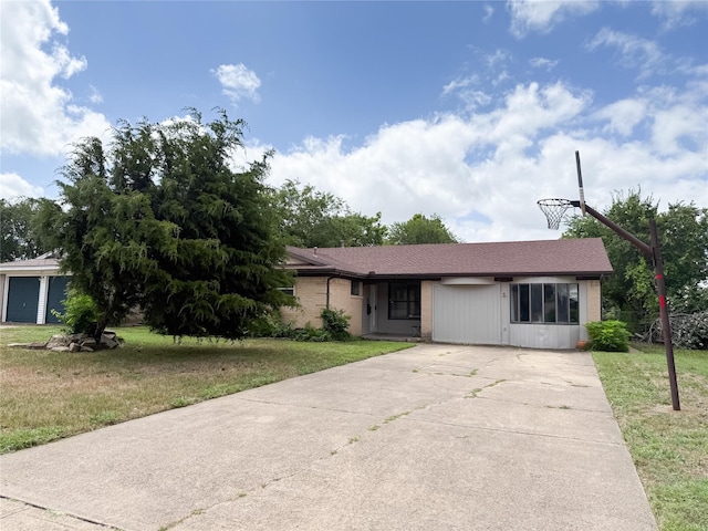 509 Cambridge, Richardson, TX 75080 - view of front of home featuring driveway, a front lawn, and brick siding