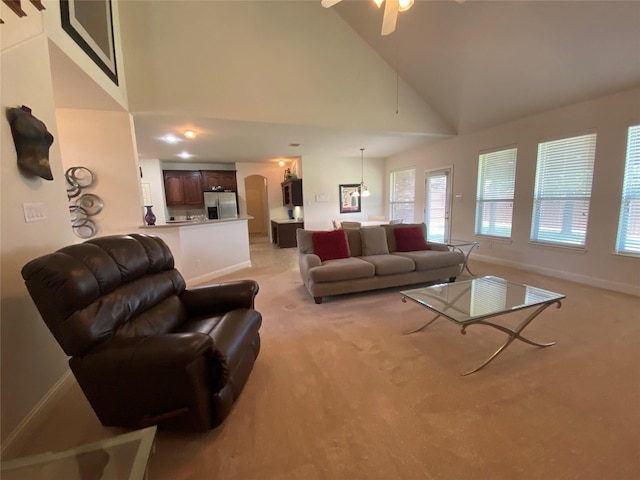 740 Bridgeport Ln, Prosper, TX 75078 - living area featuring light carpet, a ceiling fan, high vaulted ceiling, and arched walkways
