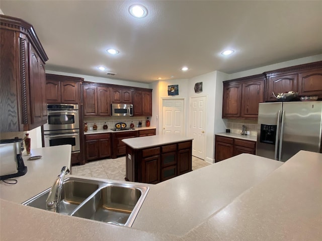 740 Bridgeport Ln, Prosper, TX 75078 - kitchen with appliances with stainless steel finishes, decorative backsplash, recessed lighting, light countertops, and dark brown cabinets