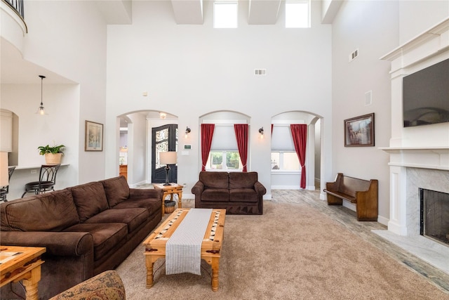 100 Redtail Hawk Dr, Aledo, TX 76008 - living room featuring arched walkways, a towering ceiling, and a fireplace