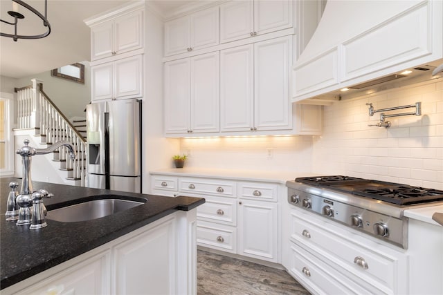 100 Redtail Hawk Dr, Aledo, TX 76008 - kitchen with stainless steel appliances, white cabinets, custom range hood, and decorative backsplash