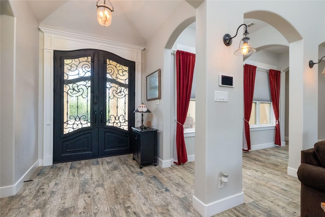 100 Redtail Hawk Dr, Aledo, TX 76008 - foyer entrance featuring french doors, arched walkways, wood finished floors, and lofted ceiling