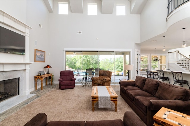 100 Redtail Hawk Dr, Aledo, TX 76008 - living room featuring a towering ceiling, stairway, a fireplace, and plenty of natural light