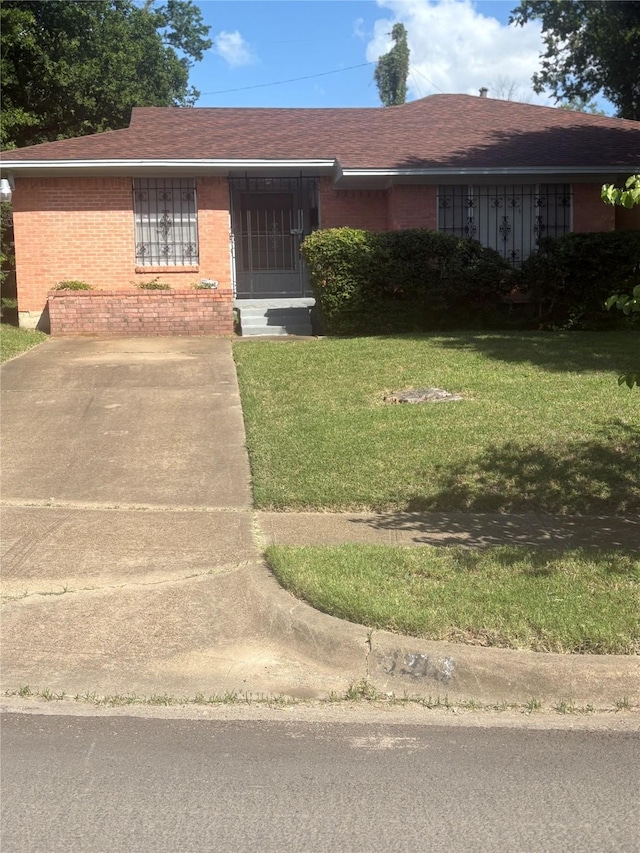 3916 Kushla Ave, Dallas, TX 75216 - ranch-style home with brick siding, a front lawn, and a shingled roof