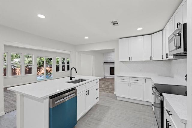 6401 Simmons Rd, North Richland Hills, TX 76182 - kitchen featuring dishwashing machine, range with electric stovetop, stainless steel microwave, recessed lighting, and white cabinets