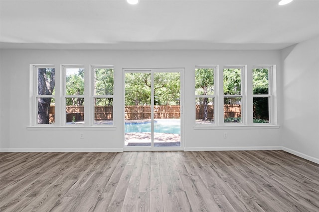 6401 Simmons Rd, North Richland Hills, TX 76182 - unfurnished living room featuring healthy amount of natural light, wood finished floors, and recessed lighting