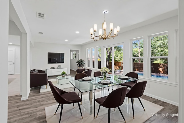 6401 Simmons Rd, North Richland Hills, TX 76182 - dining area with light wood-style floors, a chandelier, and recessed lighting