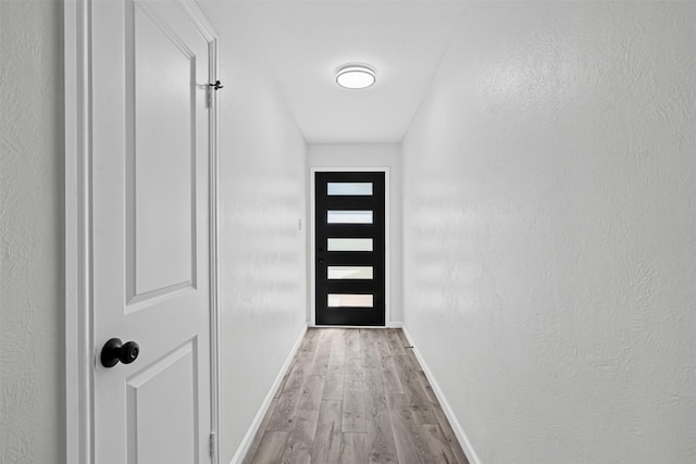 6401 Simmons Rd, North Richland Hills, TX 76182 - doorway to outside featuring wood finished floors and baseboards