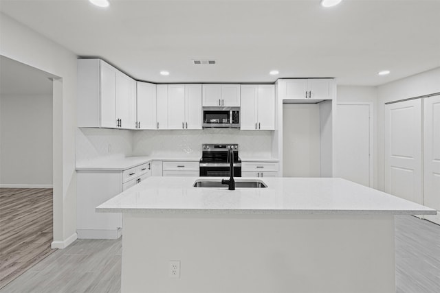 6401 Simmons Rd, North Richland Hills, TX 76182 - kitchen featuring appliances with stainless steel finishes, light wood-type flooring, recessed lighting, backsplash, and white cabinetry