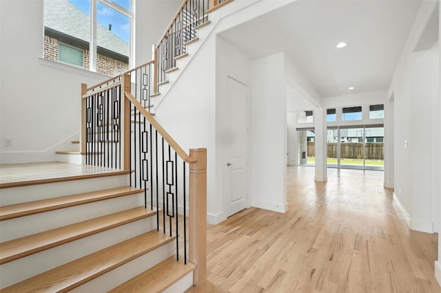 13868 Dorset Ln, Frisco, TX 75035 - stairs featuring plenty of natural light, wood finished floors, and recessed lighting