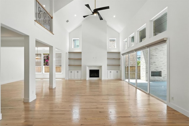 13868 Dorset Ln, Frisco, TX 75035 - unfurnished living room with a fireplace, high vaulted ceiling, hardwood / wood-style flooring, ceiling fan, and built in features