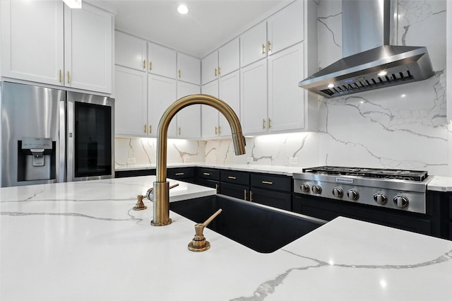 13868 Dorset Ln, Frisco, TX 75035 - kitchen with wall chimney range hood, stainless steel appliances, white cabinets, and decorative backsplash