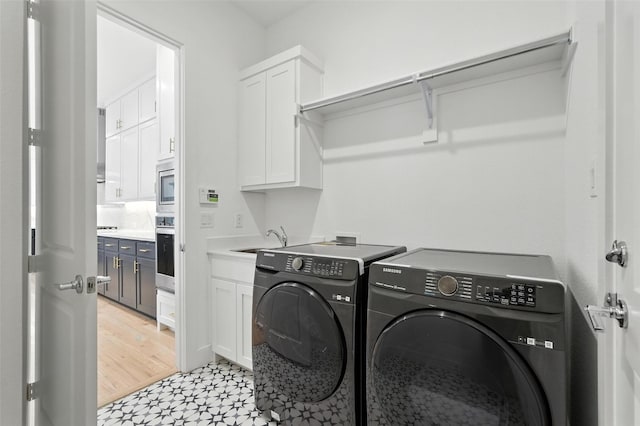 13868 Dorset Ln, Frisco, TX 75035 - laundry room with washing machine and clothes dryer, cabinet space, and light floors