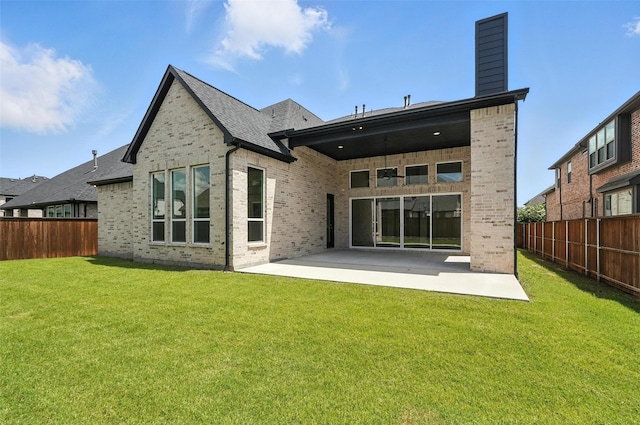 13868 Dorset Ln, Frisco, TX 75035 - rear view of house featuring a fenced backyard, a patio, brick siding, and a chimney