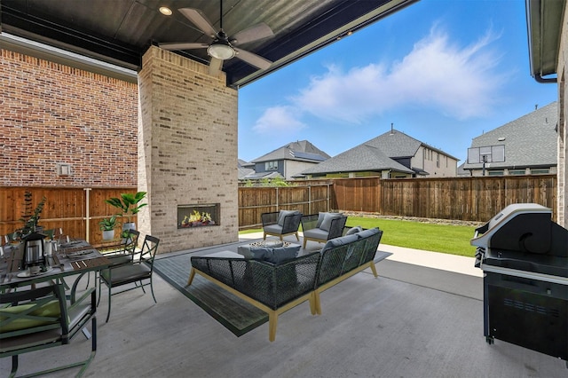 13868 Dorset Ln, Frisco, TX 75035 - fenced backyard featuring a patio, ceiling fan, an outdoor living space with a fireplace, and a grill