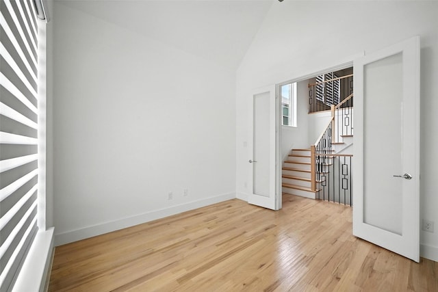 13868 Dorset Ln, Frisco, TX 75035 - spare room with stairs, wood finished floors, and high vaulted ceiling