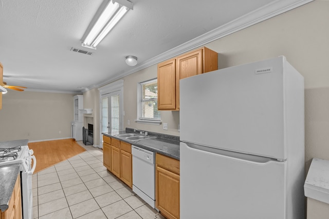 5308 Wentworth St, Fort Worth, TX 76132 - kitchen with white appliances, a fireplace, crown molding, open floor plan, and light tile patterned floors