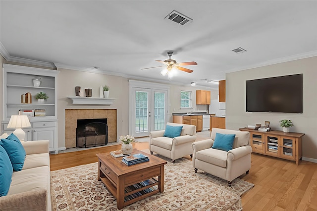 5308 Wentworth St, Fort Worth, TX 76132 - living room with ornamental molding, a ceiling fan, light wood-style floors, and a fireplace