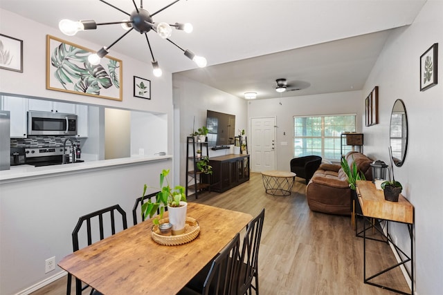 8805 Tumbleweed Dr, Cross Roads, TX 76227 - dining space featuring light wood-type flooring, a chandelier, and ceiling fan