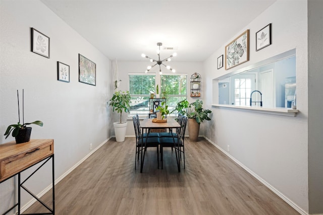 8805 Tumbleweed Dr, Cross Roads, TX 76227 - dining room with wood finished floors and a chandelier