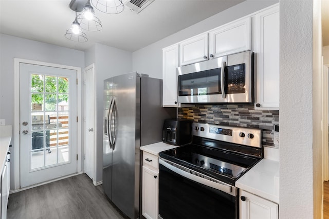 8805 Tumbleweed Dr, Cross Roads, TX 76227 - kitchen with appliances with stainless steel finishes, dark wood-style floors, light countertops, and white cabinets