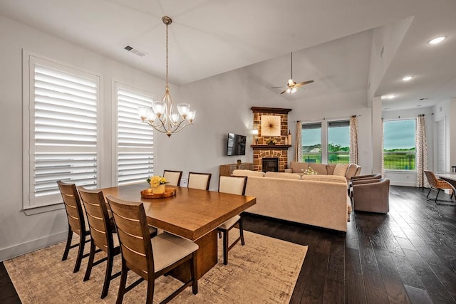 778 Corner Post Path, Celina, TX 75009 - dining room with a fireplace, dark wood finished floors, ceiling fan, a chandelier, and recessed lighting