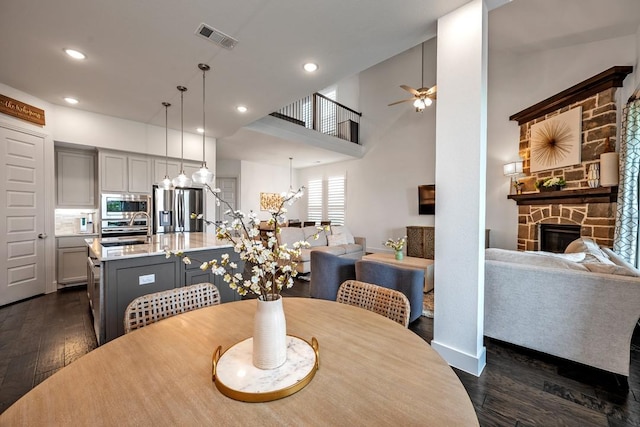 778 Corner Post Path, Celina, TX 75009 - dining space featuring dark wood finished floors, a fireplace, ceiling fan, recessed lighting, and a chandelier