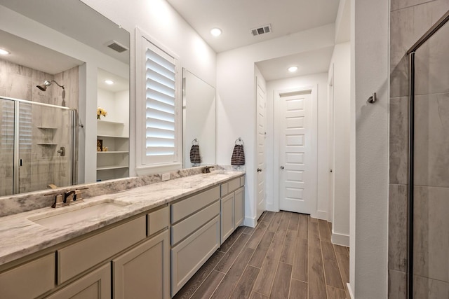 778 Corner Post Path, Celina, TX 75009 - bathroom featuring a shower stall, double vanity, wood finish floors, recessed lighting, and a closet