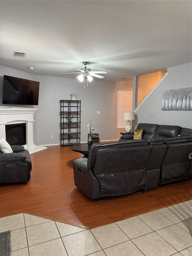 2100 Leandra Ln, Fort Worth, TX 76131 - tiled living area featuring a ceiling fan and a fireplace with raised hearth