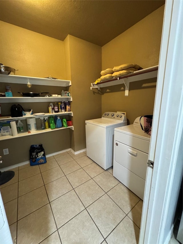 2100 Leandra Ln, Fort Worth, TX 76131 - laundry area featuring independent washer and dryer, light tile patterned floors, and a textured ceiling