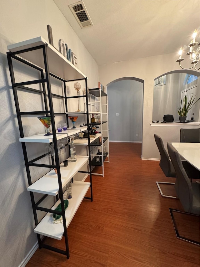 2100 Leandra Ln, Fort Worth, TX 76131 - home office with arched walkways, wood finished floors, and a chandelier