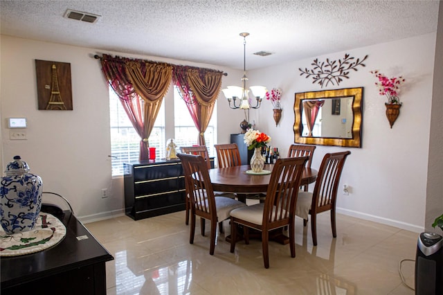 1313 Forbes Dr, Garland, TX 75040 - dining space featuring a chandelier, a textured ceiling, and light tile patterned floors