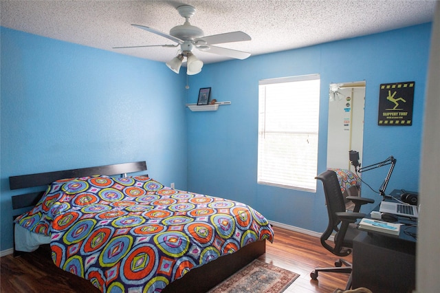 1313 Forbes Dr, Garland, TX 75040 - bedroom with wood finished floors, a textured ceiling, and ceiling fan