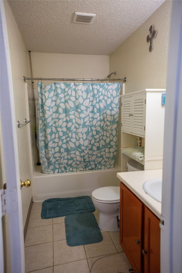 1313 Forbes Dr, Garland, TX 75040 - bathroom with shower / tub combo, vanity, a textured ceiling, and tile patterned floors