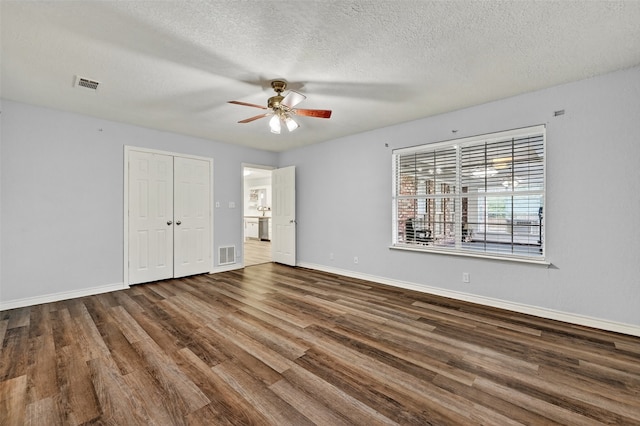 2107 Meadows Cir, Sherman, TX 75092 - unfurnished bedroom with wood finished floors, a textured ceiling, ceiling fan, and a closet
