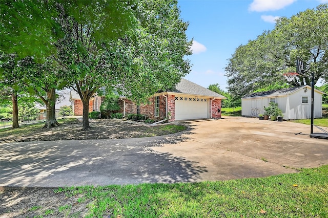 2107 Meadows Cir, Sherman, TX 75092 - view of front of home featuring brick siding, an attached garage, driveway, an outdoor structure, and roof with shingles