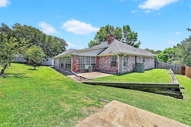 2107 Meadows Cir, Sherman, TX 75092 - back of property featuring a patio, brick siding, a chimney, and roof with shingles